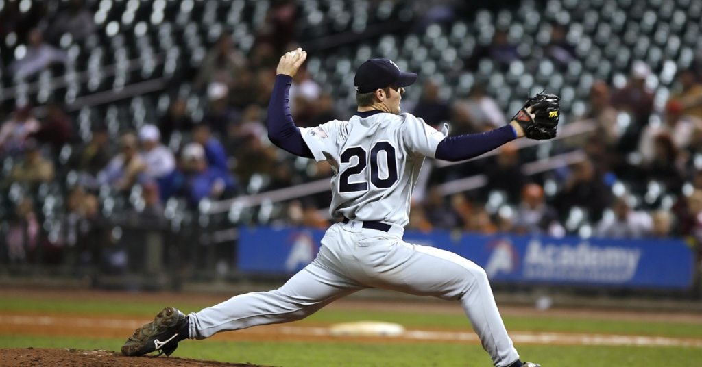 Baseball athlete throwing a pitch off the mound in an MLB game.