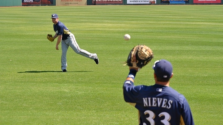 Baseball athletes playing catch in the outfield