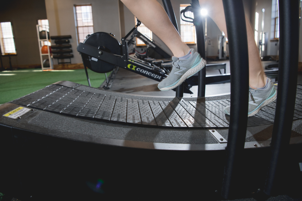 Athlete running on treadmill during sports physical therapy.