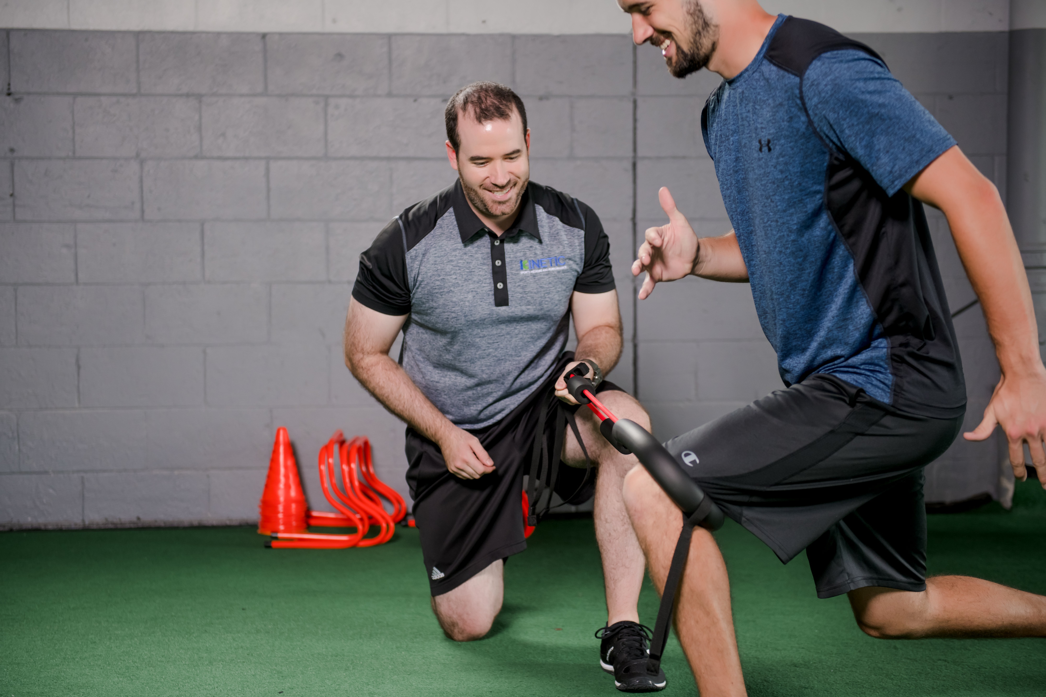 Physical therapist testing strength of a patient.