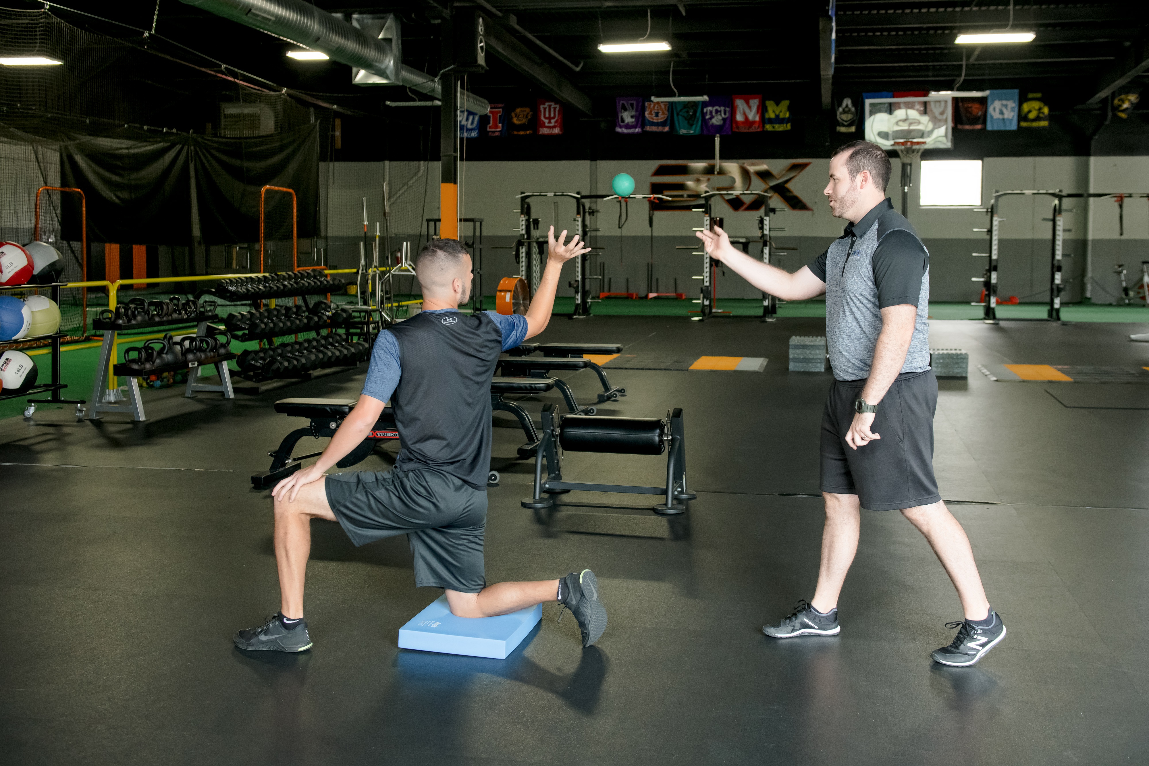 Baseball player running through arm care routine.