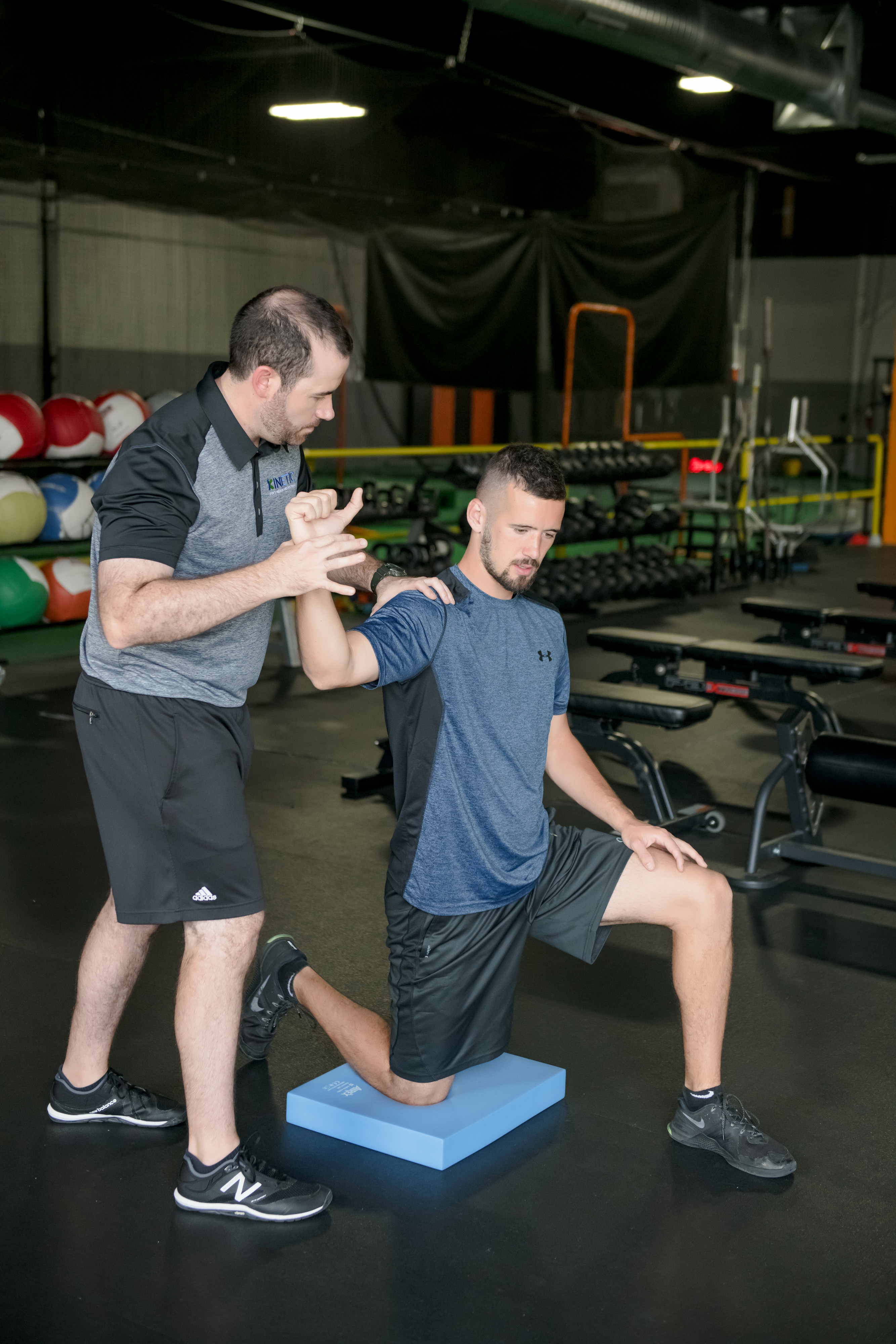 Throwing athlete works on shoulder range of motion with physical therapist.