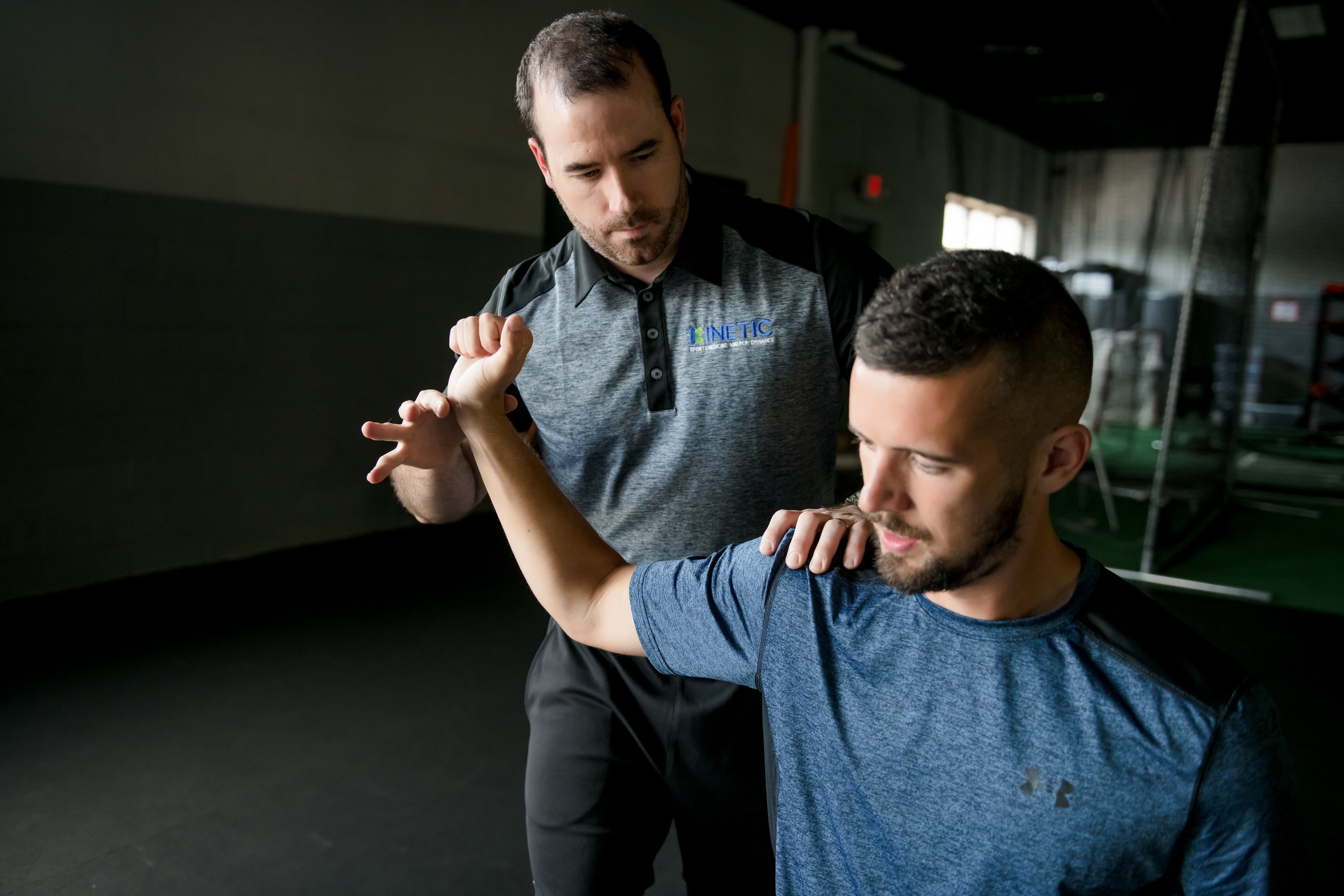 Physical therapist works on throwing patient.