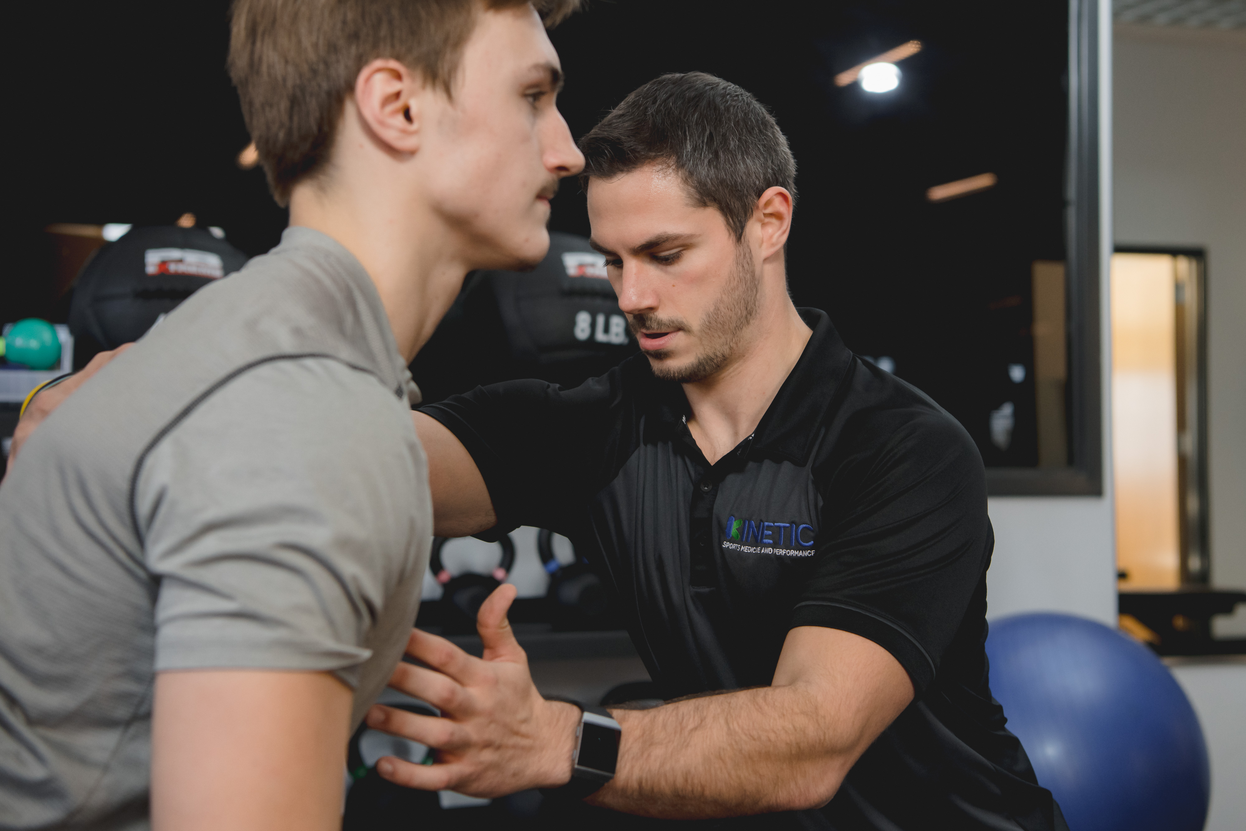 Physical therapist assisting in lifting form