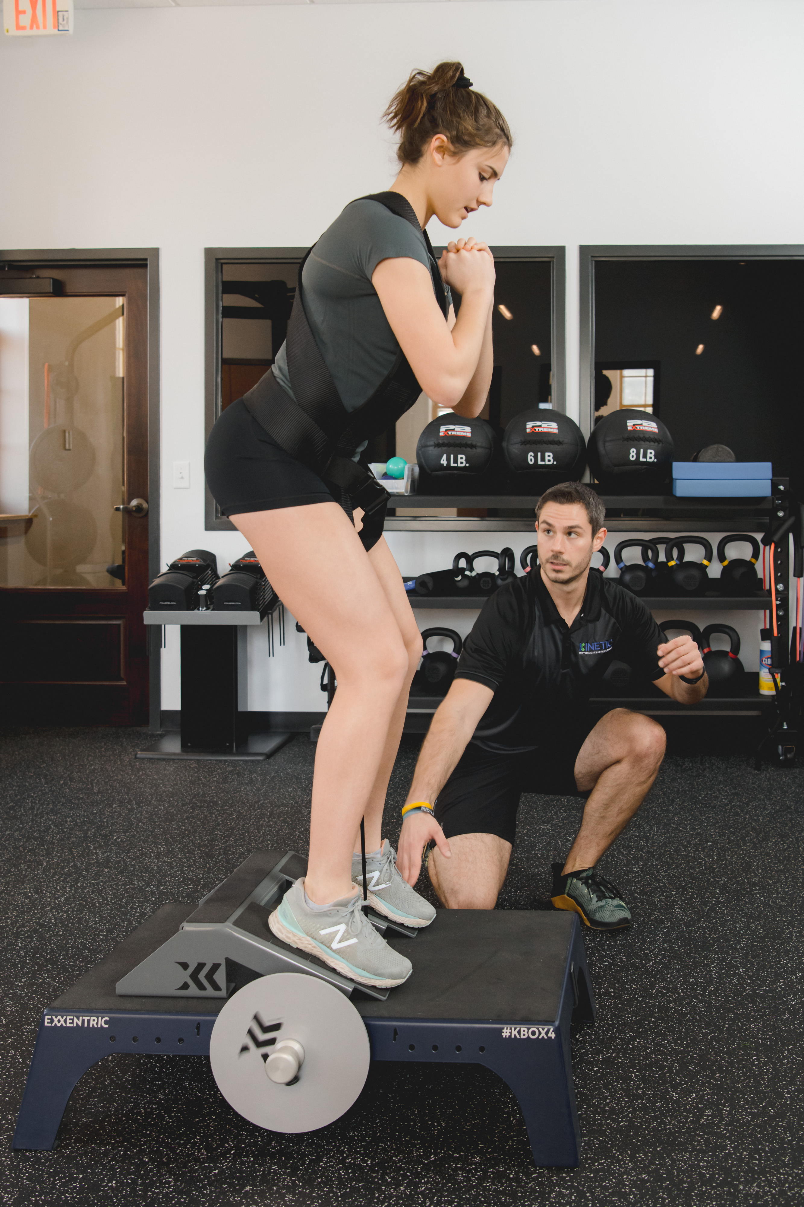 Physical therapist testing strength with patient.