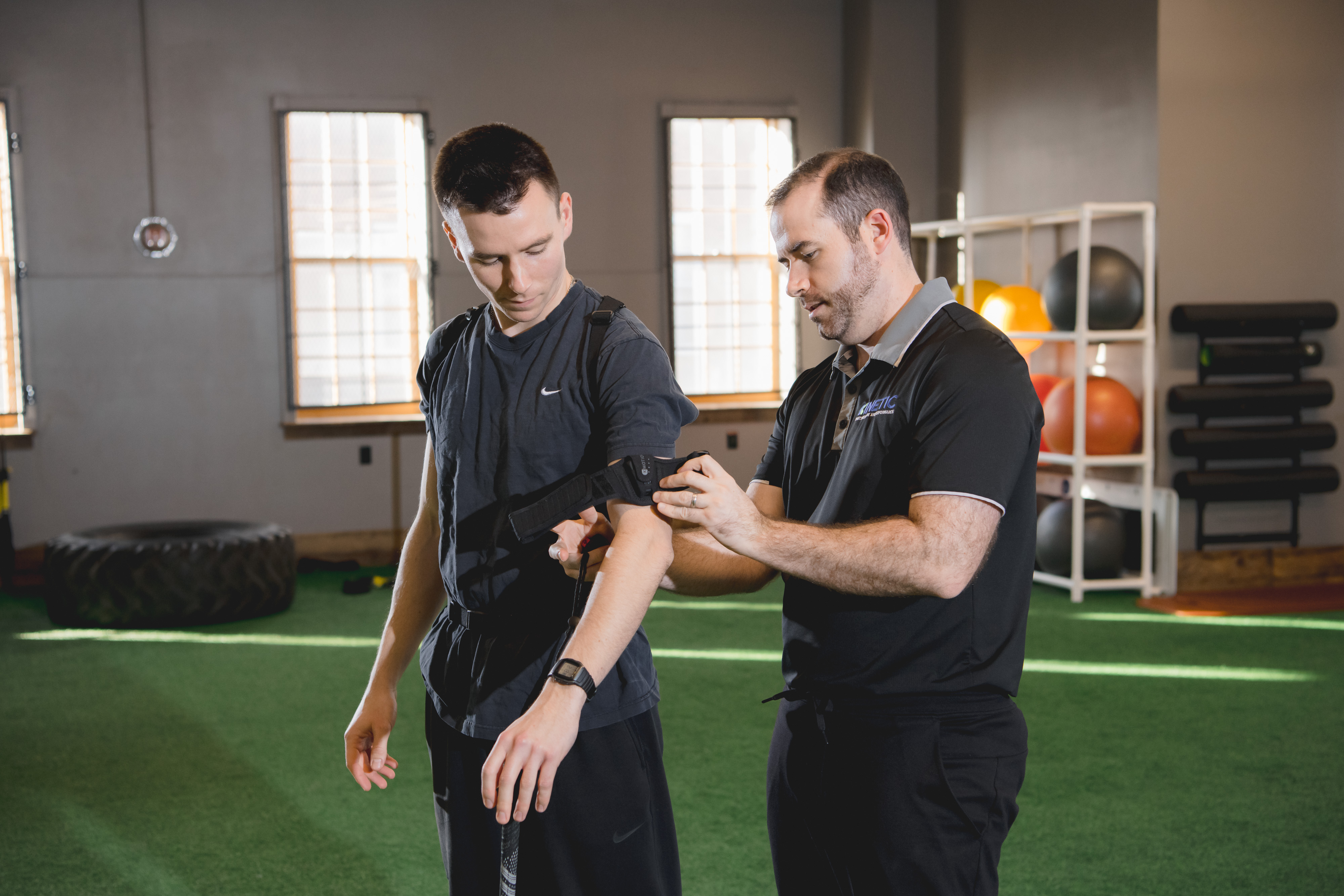 Golfer being fitted for 3D motion analysis during sports physical therapy.