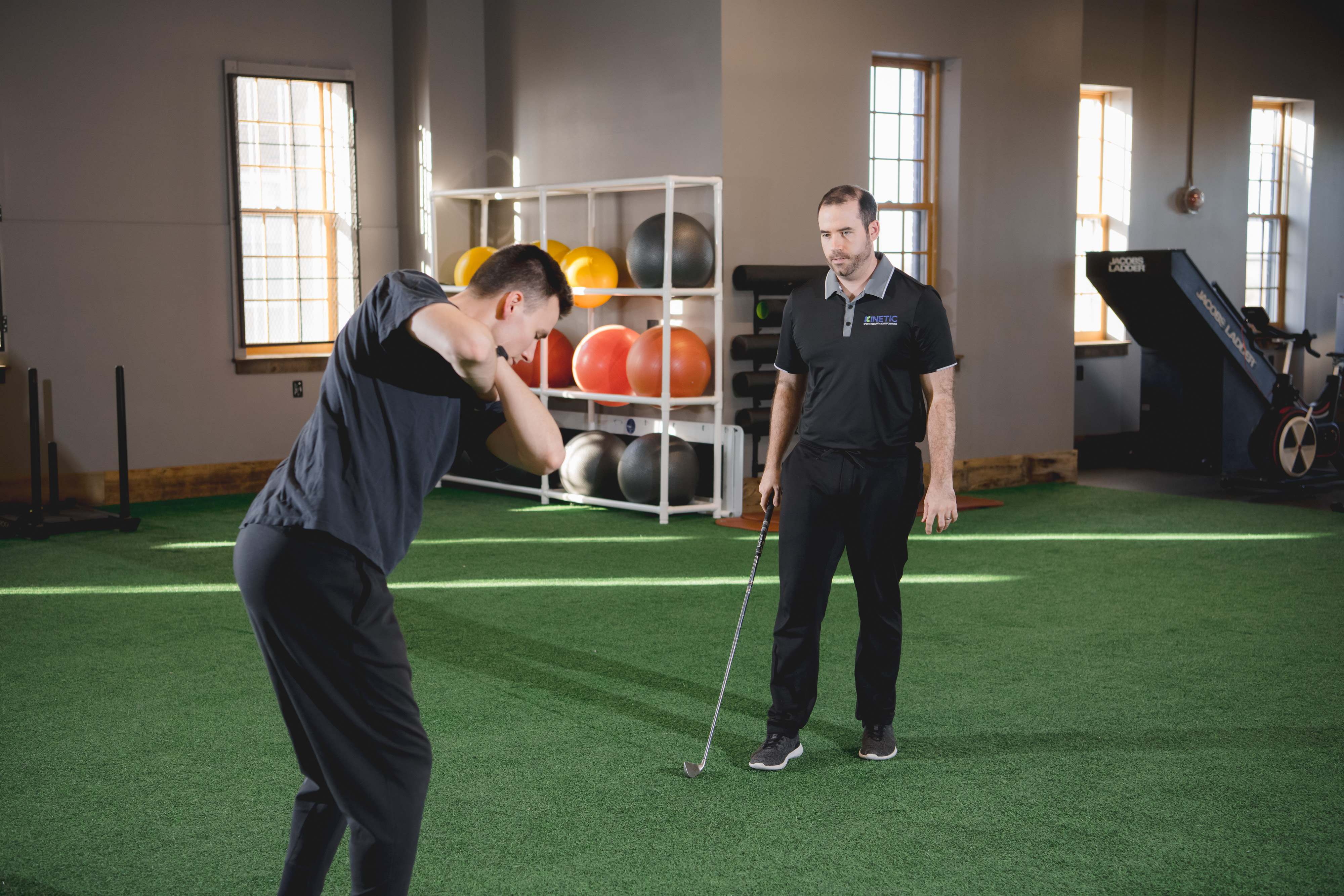 Physical therapist working with golf patient