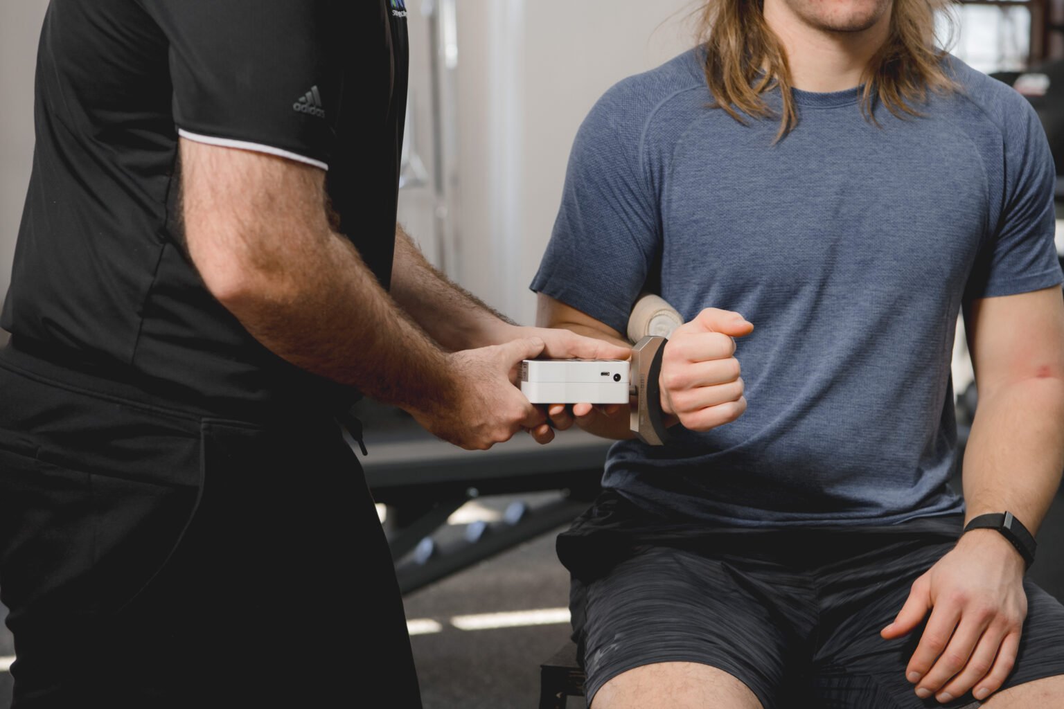 Athlete measuring external rotation during sports physical therapy.