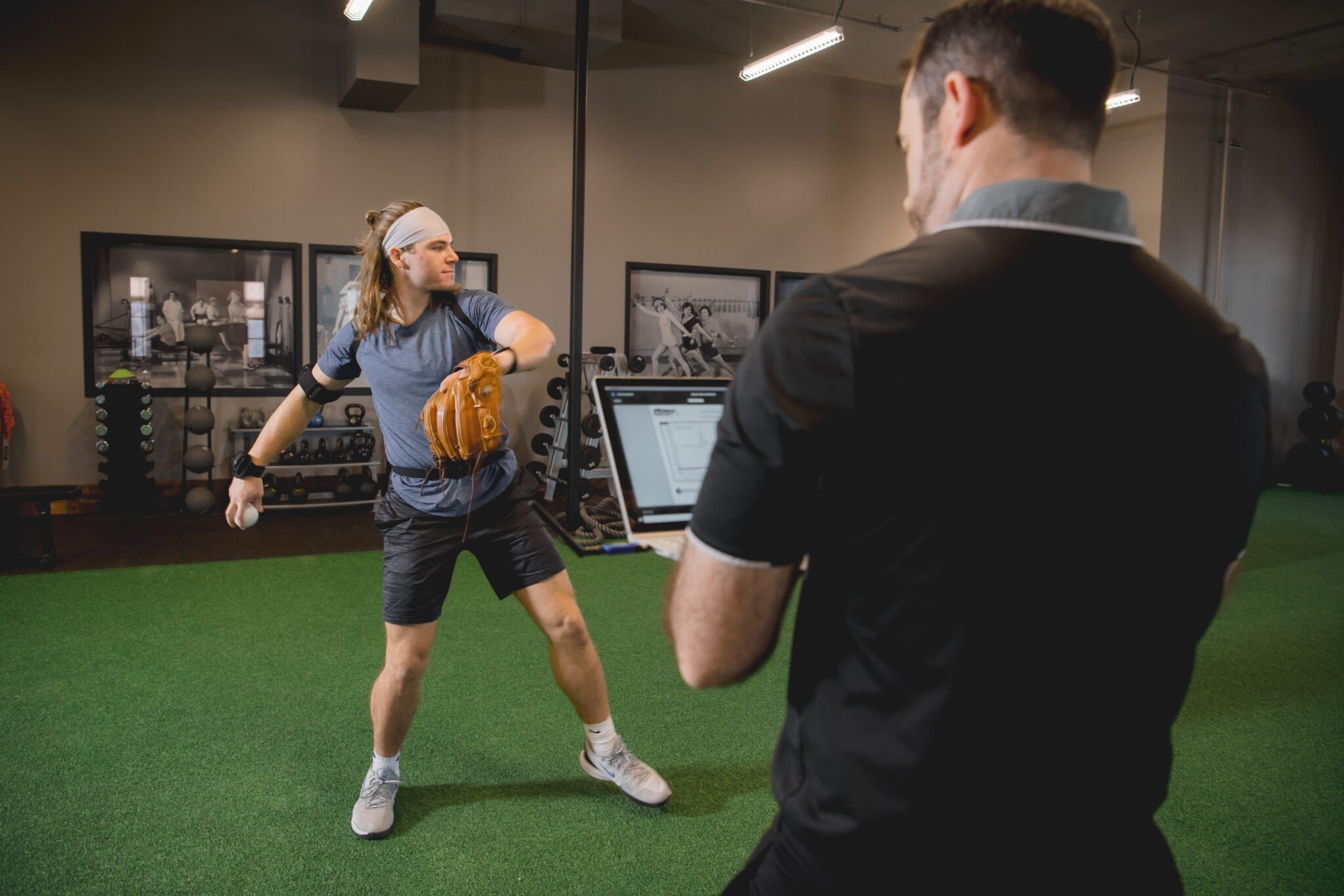 Athlete throwing with monitoring equipment during sports physical therapy.