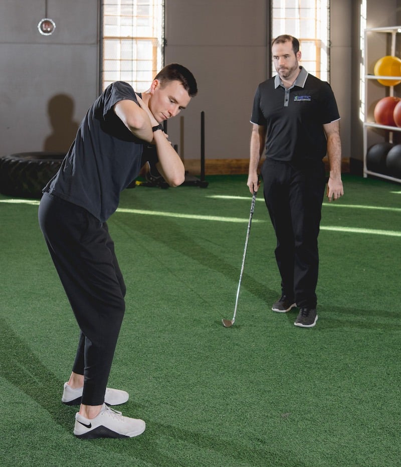 Golfer being assessed during sports physical therapy.